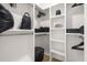 Walk-in closet featuring shelves, clothes racks, and a wooden floor at 201 New St # 2301, Decatur, GA 30030