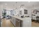 Open-concept kitchen with a modern island, sleek appliances, and dining area at 201 New St # 2301, Decatur, GA 30030