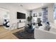 Bright living room with stylish decor, balcony access, and a view into a bedroom at 201 New St # 2301, Decatur, GA 30030
