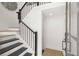 Elegant staircase featuring dark wood steps, black railings, and white walls at 201 New St # 2301, Decatur, GA 30030