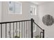 Modern staircase showcasing black railings and white walls, with natural light at 201 New St # 2301, Decatur, GA 30030