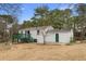 The home has a green deck, a lush green lawn, and it is near a tree-filled area at 3063 Kerr Dr, Decatur, GA 30034