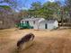 View of a backyard showing a home's exterior, green deck, and grassy lawn at 3063 Kerr Dr, Decatur, GA 30034