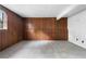 Spacious basement with wood paneled walls and neutral gray carpet at 3063 Kerr Dr, Decatur, GA 30034