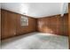 Spacious basement with wood paneled walls and neutral gray carpet at 3063 Kerr Dr, Decatur, GA 30034