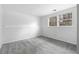 Bright bedroom features neutral gray carpet and natural light from double windows at 3063 Kerr Dr, Decatur, GA 30034