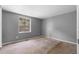 Bedroom with a large window offering ample natural light, plus neutral colored walls and carpet at 3063 Kerr Dr, Decatur, GA 30034
