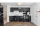 Well-lit kitchen showcasing sleek black appliances, cabinets, and hardwood floors at 3063 Kerr Dr, Decatur, GA 30034