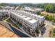 Aerial view of new construction townhomes with street access and green space at 201 New St # 2305-1, Decatur, GA 30030