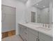 Modern bathroom with double sinks, a large mirror, and a walk-in shower at 201 New St # 2305-1, Decatur, GA 30030
