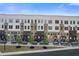 Modern townhomes with brick and white siding, landscaped yards, and sidewalk access at 201 New St # 2305-1, Decatur, GA 30030