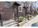 View of new townhomes featuring a brick facade and individual entryways with wrought iron railings at 201 New St # 2305-1, Decatur, GA 30030