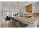 Bright, open kitchen boasts a large island, stainless steel appliances, and modern pendant lighting at 201 New St # 2305-1, Decatur, GA 30030