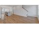 Open-concept living space with hardwood floors, kitchen view and white walls at 201 New St # 2305-1, Decatur, GA 30030