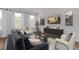 Comfortable living room featuring neutral decor, hardwood floors and large windows at 201 New St # 2305-1, Decatur, GA 30030