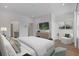 Serene main bedroom featuring plush bedding, a sitting area, and hardwood floors at 201 New St # 2305-1, Decatur, GA 30030