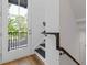 Bright stairwell with modern railing and a view to a balcony with black rails at 201 New St # 2305-1, Decatur, GA 30030
