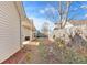 Side view of cozy home with charming patio, fenced yard, and blue umbrella for relaxing outdoors at 37 Village Dr, Cartersville, GA 30121