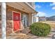 Welcoming front entrance featuring a bright red door, stone accents, and well-kept landscaping at 37 Village Dr, Cartersville, GA 30121