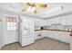 Bright kitchen featuring tile floors, white cabinets, wood countertops and modern appliances for a functional cooking space at 37 Village Dr, Cartersville, GA 30121