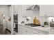 Close-up of a modern kitchen featuring white cabinets, stainless steel appliances, and ample counter space at 3730 Near Star Ln, Cumming, GA 30028