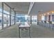 Modern lounge area with a long table, bar with stools, and floor-to-ceiling windows with city views at 845 Spring Nw St # 322, Atlanta, GA 30308