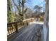 Spacious back deck with a view of trees and a white table with chairs, perfect for outdoor relaxation at 3875 Wintergreen Ct, Marietta, GA 30062