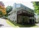 Back exterior featuring a spacious deck, white siding, and a well-manicured lawn at 3875 Wintergreen Ct, Marietta, GA 30062