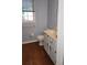 Bathroom featuring a white vanity, light blue walls, wood-look flooring, and a window at 3875 Wintergreen Ct, Marietta, GA 30062