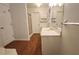Bright bathroom with wood-look floors, white cabinets, and large mirror at 3875 Wintergreen Ct, Marietta, GA 30062