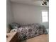 Cozy bedroom with a patterned bedspread and natural light from the window at 3875 Wintergreen Ct, Marietta, GA 30062