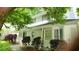 View of the home's exterior featuring a long front porch with a white railing and a colorful teal front door at 3875 Wintergreen Ct, Marietta, GA 30062