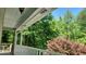 Inviting view from the porch, featuring a combination of mature trees, landscaping, and an inviting outdoor seating area at 3875 Wintergreen Ct, Marietta, GA 30062