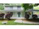 Charming front porch of this light blue two-story home, featuring a well-manicured yard and stone bird bath at 3875 Wintergreen Ct, Marietta, GA 30062