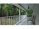 Inviting front porch with a swing, chair, and peaceful views of the lush surroundings at 3875 Wintergreen Ct, Marietta, GA 30062