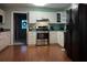 Efficient kitchen with stainless steel oven, range hood, bright cabinets and hard surface flooring at 3875 Wintergreen Ct, Marietta, GA 30062