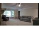 Inviting living room with a large bay window, ceiling fan, neutral color palette and comfortable seating arrangements at 3875 Wintergreen Ct, Marietta, GA 30062