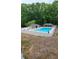 Community pool area featuring a large swimming pool, surrounding fence, and covered seating areas at 3875 Wintergreen Ct, Marietta, GA 30062