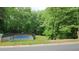 Outdoor tennis court surrounded by lush trees offers residents a space for active recreation at 3875 Wintergreen Ct, Marietta, GA 30062