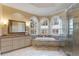 Bright bathroom with granite countertops, a soaking tub, and a glass-enclosed shower at 715 Newport Holw, Alpharetta, GA 30005