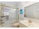 Bright bathroom offers a shower and tub combination and a single sink vanity at 715 Newport Holw, Alpharetta, GA 30005