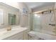 This bathroom features a tub/shower combination with glass door, and a vanity with gold fixtures at 715 Newport Holw, Alpharetta, GA 30005
