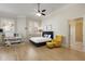 Bright bedroom with hardwood floors, yellow accent chair, and window with plantation shutters at 715 Newport Holw, Alpharetta, GA 30005