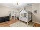 Charming bedroom with hardwood floors features a house-frame bed and built-in shelving at 715 Newport Holw, Alpharetta, GA 30005