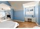 Light filled bedroom features hardwood floors, a ceiling fan, and custom built-ins at 715 Newport Holw, Alpharetta, GA 30005