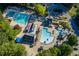 Aerial view of community pools with lounge chairs, tables, and a waterslide at 715 Newport Holw, Alpharetta, GA 30005