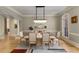 Sophisticated dining room with stylish chandelier, complemented by hardwood floors and soft, neutral colors at 715 Newport Holw, Alpharetta, GA 30005