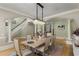 Dining room featuring a chandelier, a table with six chairs, and hardwood flooring throughout at 715 Newport Holw, Alpharetta, GA 30005