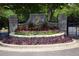 Golf Community entrance sign surrounded by colorful flowerbeds and beautiful landscaping at 715 Newport Holw, Alpharetta, GA 30005