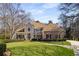 Imposing two-story brick home with manicured lawn and mature trees exuding curb appeal and classic charm at 715 Newport Holw, Alpharetta, GA 30005